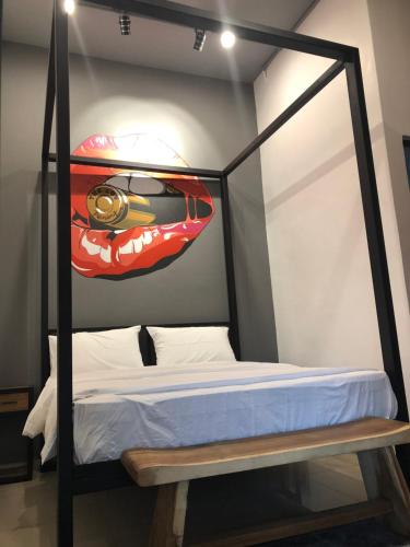 a bedroom with a bed with a car on the wall at The Best Hotel in Bayan Lepas - THE LOV PENANG in Bayan Lepas