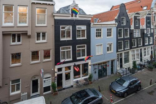 a group of buildings with cars parked in front of them at Amistad hotel in Amsterdam