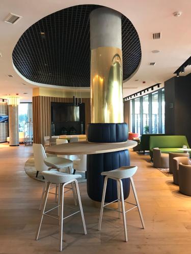 a lobby with a table and chairs in a building at Vincci Consulado de Bilbao in Bilbao