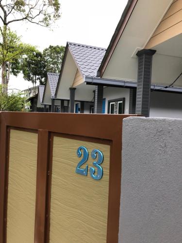 a gate with the number on it in front of a house at The Temak Villa in Pantai Cenang