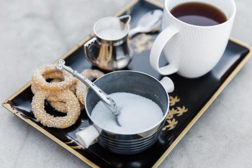 a tray with a cup of coffee and a pretzel at Vineyard Views Country House in Riebeek-Kasteel