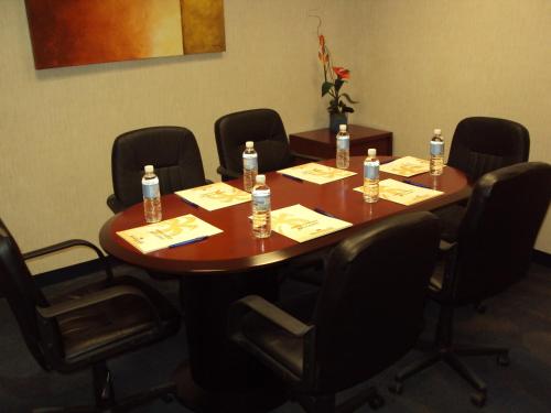 a conference room with a table with bottles of water on it at Rio Vista Inn Business High Class Hotel Poza Rica in Poza Rica de Hidalgo