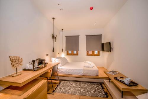 a bedroom with a bed and a desk and a table at Portou House in Chania Town