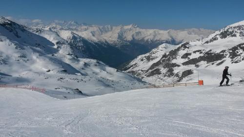 a person is skiing down a snow covered mountain at Montagne Duplex-Orelle 9 pers. avec SPA in Orelle