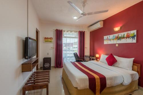 a hotel room with a bed and a tv at Hotel Raha Tower in Dar es Salaam