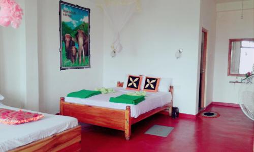 a bedroom with two beds and a painting on the wall at Broad view in Ella
