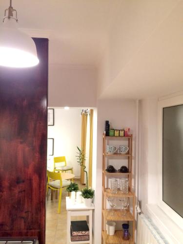 a hallway with a living room with a tv at My Little Studio in Bucharest
