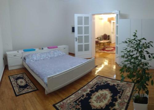 a bedroom with a bed and two rugs at Resident hill resort in Belgrade
