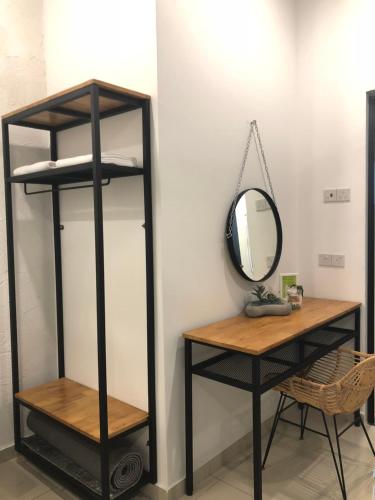 a shelf with a mirror and a table at The Best Hotel in Bayan Lepas - THE LOV PENANG in Bayan Lepas