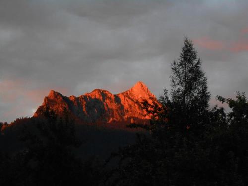a mountain with the sun shining on it at Haus Heiserer in Musau