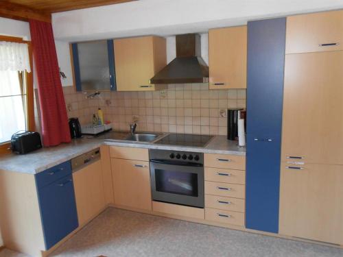 a kitchen with a sink and a stove top oven at Haus Heiserer in Musau
