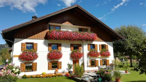 a house with flowers on the side of it at Haus Heiserer in Musau