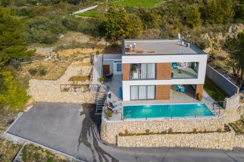 an aerial view of a house with a swimming pool at Royal Villa 2 in Podstrana