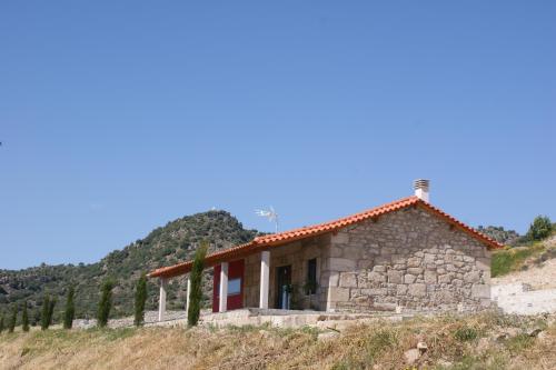 a stone house on top of a hill at Quinta da Terrincha in Torre de Moncorvo