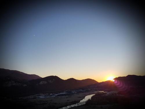 a sunset over a mountain range with the sun setting at Amata Valgre Affittacamere, comfort e pulizia eccezionali!! in Olginate