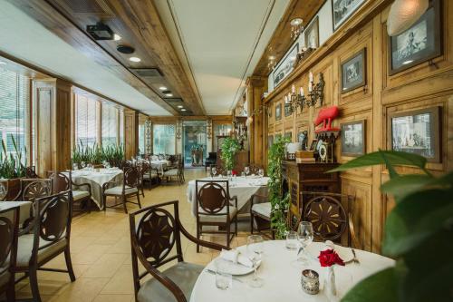 a restaurant with tables and chairs and wooden walls at Vinotel Boutique Hotel in Tbilisi City