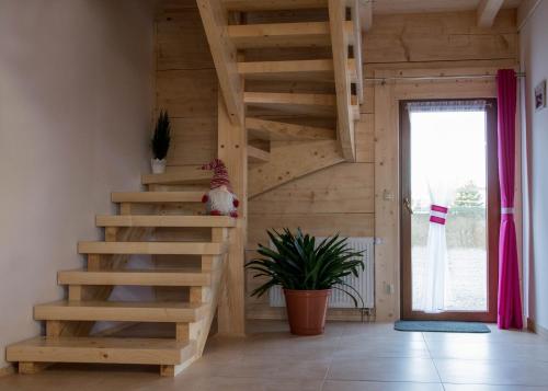 a wooden staircase in a room with a window at Dwór Pan Tadeusz in Orawka