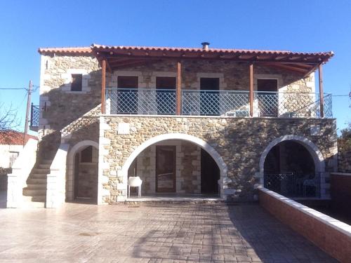 a stone building with an archway in front of it at Mystras Inn in Mystras
