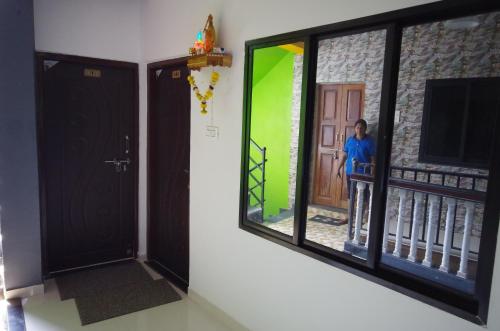 a man is standing in front of a window at Angelo's place in Arambol