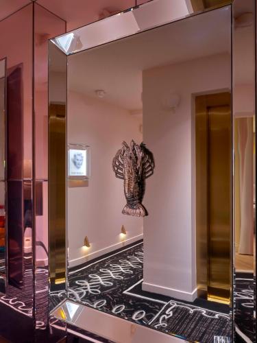 a large mirror in a room with a black floor at 9Confidentiel in Paris