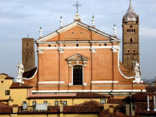 a large building with two towers and a clock tower at Hotel Palace Bologna Centro in Bologna