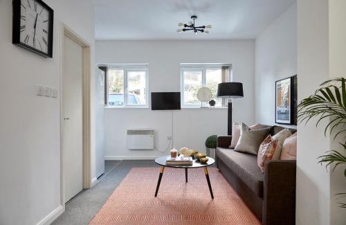 a living room with a couch and a table at Aisiki Living at Upton Road, Multiple 1, 2, or 3-Bedroom Apartments, King or Twin Beds with Free Wi-Fi & Parking Space in Watford