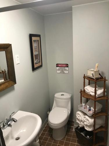 a bathroom with a white toilet and a sink at ★ Gorgeous Patio Room at Casa of Essence located in ♥ of Old San Juan ★ in San Juan