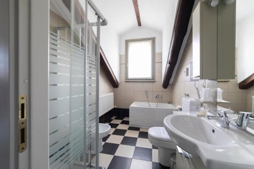 a bathroom with a sink and a toilet and a tub at Cascina Marchesa in Turin