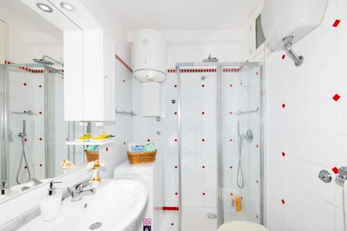 a white bathroom with a shower and a sink at Blue Line House Positano in Positano