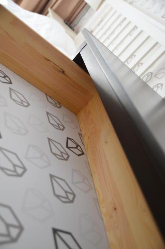 a close up of a piece of wood on a bed at SAKÀ Vacation House in Druskininkai