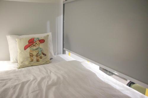 a bed with a pillow with a scarecrow on it at Hanoi Banana Hostel in Hanoi