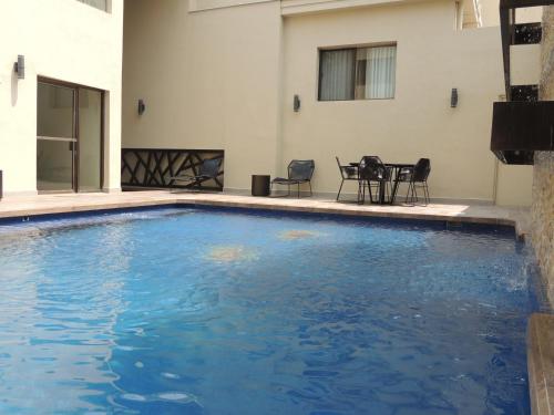 a swimming pool with blue water in a building at Antaris Valle in Monterrey