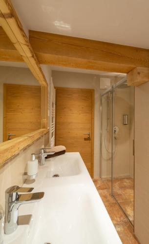 a bathroom with a white sink and a shower at Haus Horngacher in Fieberbrunn