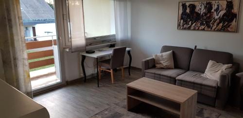 a living room with a couch and a table at Akzent Hotel Gut Höing in Unna