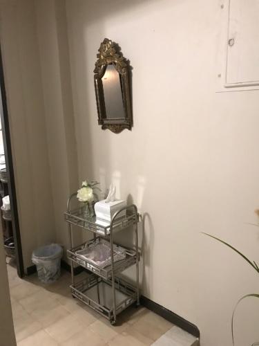 a mirror on a wall next to a shelf at The Balconies Studio, The Marilyn Suite & The Crystal Apartment at Casa of Essence in Old San Juan in San Juan