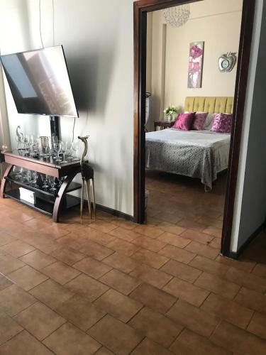 a bedroom with a bed with a mirror and a table at The Balconies Studio, The Marilyn Suite & The Crystal Apartment at Casa of Essence in Old San Juan in San Juan