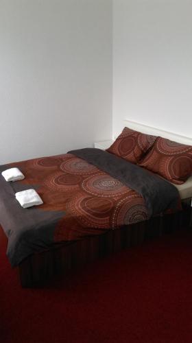a bed in a room with a red carpet at Motel Dreams in Novi Travnik