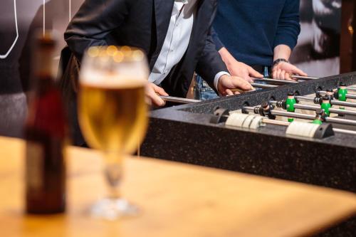 a glass of beer sitting on a table next to a keyboard at Ibis Brussels City Centre in Brussels