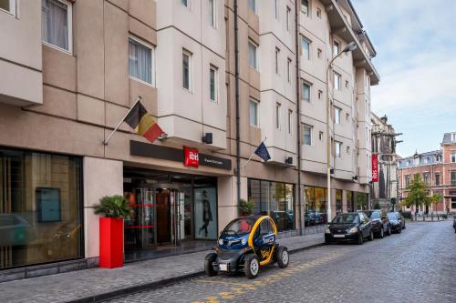 a small car parked on a street in front of buildings at Ibis Brussels City Centre in Brussels