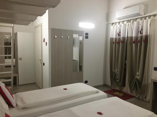 a bedroom with two beds and a mirror at B&B Nuova Ostiglia in Quinto di Treviso
