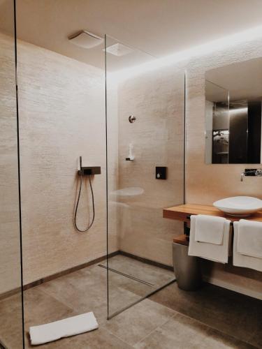 a bathroom with a glass shower and a sink at Sky Beach Aparthotel in Marina