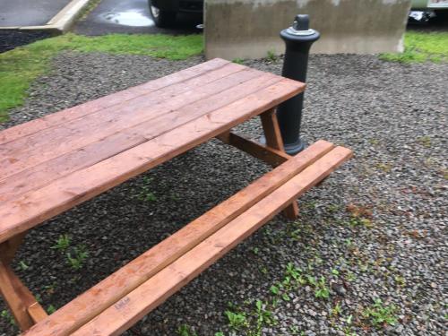 a wooden bench sitting next to a black pole at Quality Inn Airport in Moncton