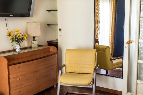 a living room with a chair and a dresser at Il Sorriso di Liu' in Agrigento