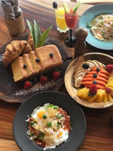 a wooden table with plates of food on it at Antera Hotel & Residences in Playa del Carmen