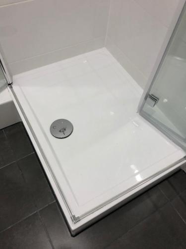 a white refrigerator with a drain in the middle at Apartment 4 Rent in Bochum