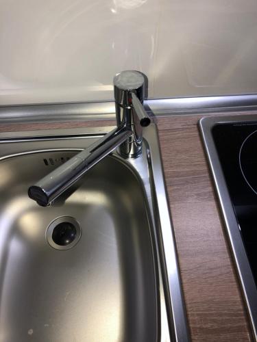 a kitchen sink with a metal faucet at Apartment 4 Rent in Bochum