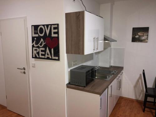 a kitchen with a counter top with a microwave at Apartment 4 Rent in Bochum