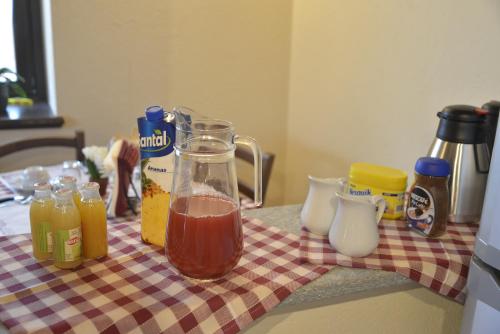 a table with a jug of juice and other ingredients at Agriturismo Ai Prüsot in Bagnolo Piemonte