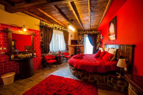 a bedroom with red walls and a bed with red pillows at Patriko Mountain Chalet in Palaios Agios Athanasios