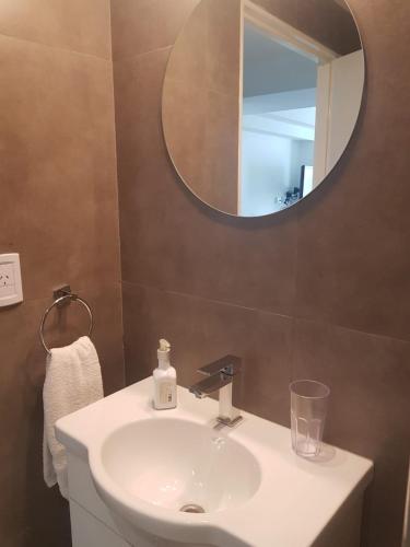 a bathroom with a sink and a mirror at Studio 5 Stars Bellini in Buenos Aires